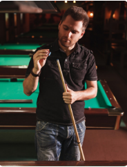 Man chalking cue stick